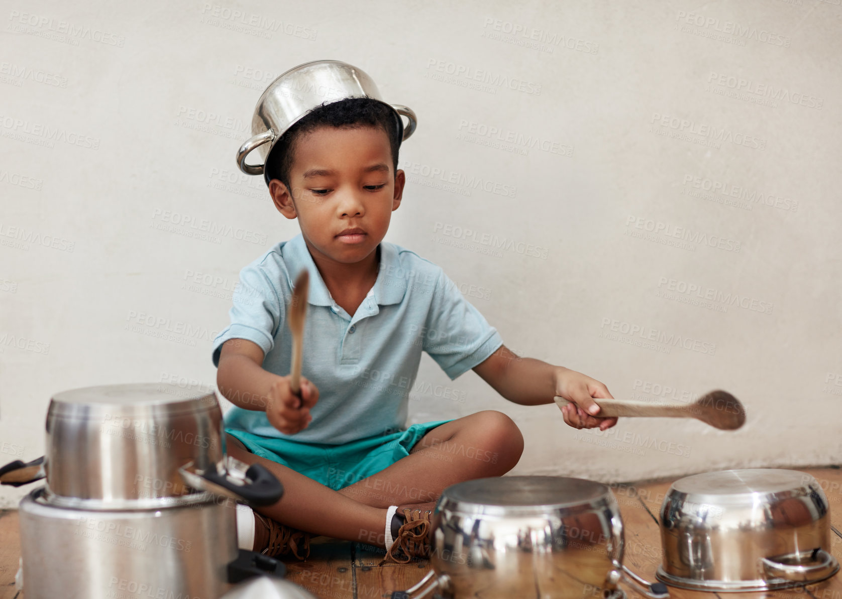 Buy stock photo Home, child and noise of pots for drum, rhythm and coordination for motor skills with metal beat. Creativity, boy musician and talent with sound, imagination and fantasy with spoon on floor in house