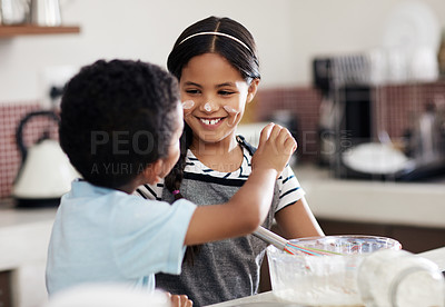 Buy stock photo Cropped shot of an adorable brother and sister baking together in the kitchen at home