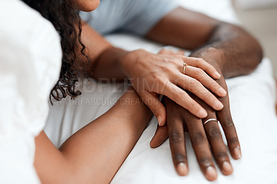 Buy stock photo Closeup of an unrecognizable couple's hands holding each other while they sleep in bed at home in the morning