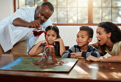 Buy stock photo Cropped shot of a young couple helping their kids with a school project