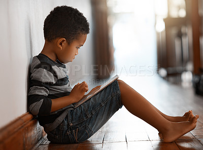 Buy stock photo Tablet, reading and African child in home on learning app, game or story for education online. Digital technology, boy and kid on internet for streaming cartoon, movie or watch show in house to relax