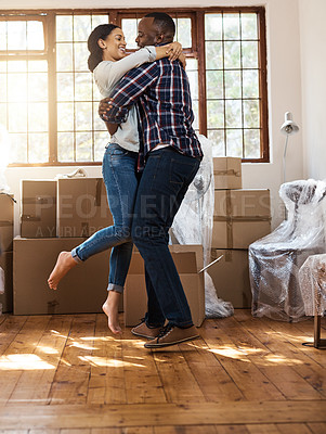Buy stock photo Shot of a young couple celebrating the move into their new place