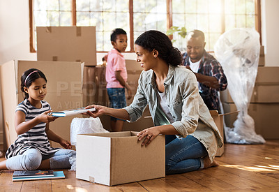 Buy stock photo Boxes, moving and family packing in home living room together with children, mom and dad. Property, real estate investment and house move with couple, kids helping box and cardboard unpacking