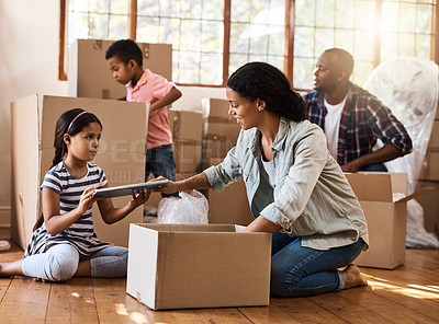 Buy stock photo Moving, family and packing boxes in home living room together with children, mom and dad. Property, real estate investment and house move with couple, kids helping box and cardboard unpacking