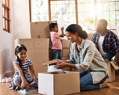 Buy stock photo Shot of a young family moving house