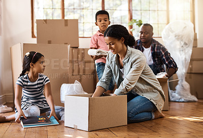 Buy stock photo Family, moving and packing boxes into home living room together with children, mom and dad. Property, real estate investment and house move with couple, kids helping box and cardboard unpacking