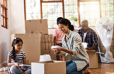 Buy stock photo Boxes, moving and family packing in home living room together with children, mom and dad. Property, real estate investment and house move with couple, kids helping box and cardboard unpacking