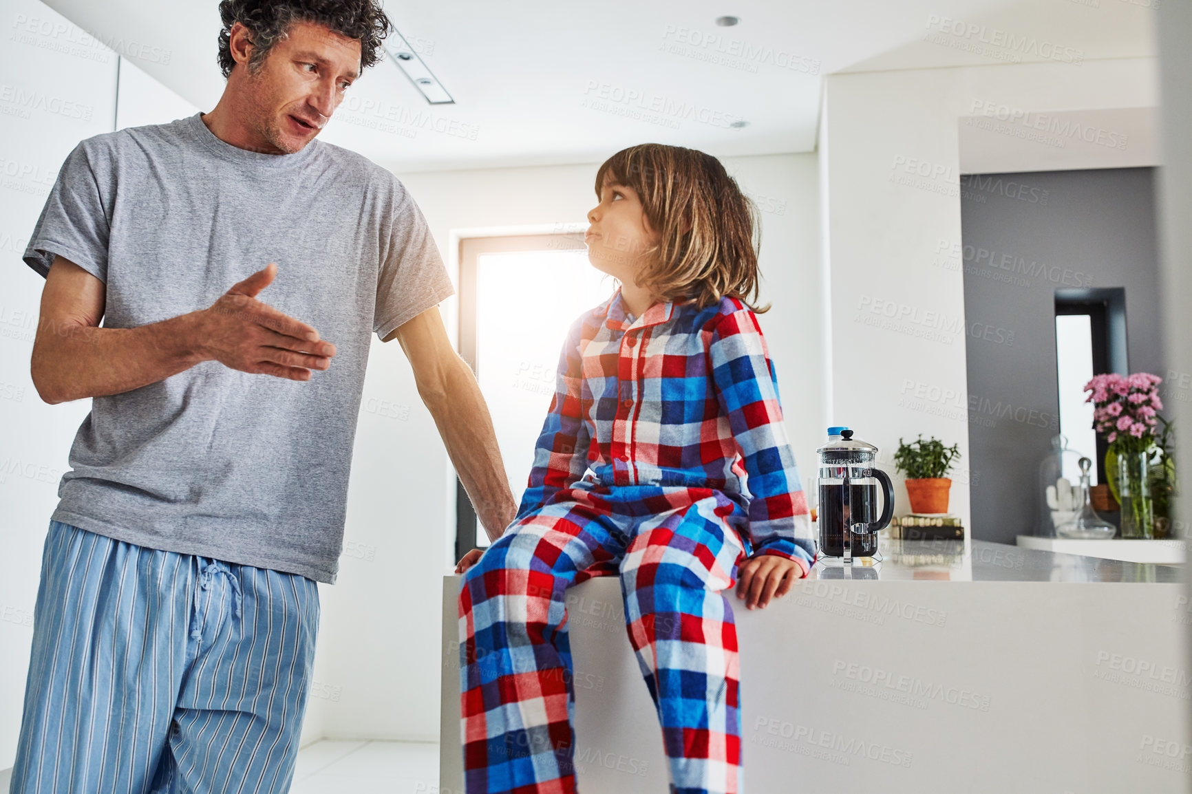 Buy stock photo Father, boy and kitchen for breakfast in home, hungry and decision on food for eating. Morning, pyjamas and negotiation for sweet brunch, dad person and child for bonding and holiday cooking together