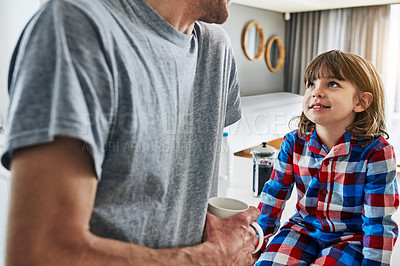 Buy stock photo Cropped shot of an unrecognizable father and his young son in the kitchen at home