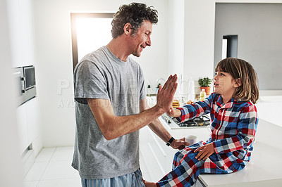 Buy stock photo Cropped shot of a mature father and his young son in the kitchen at home