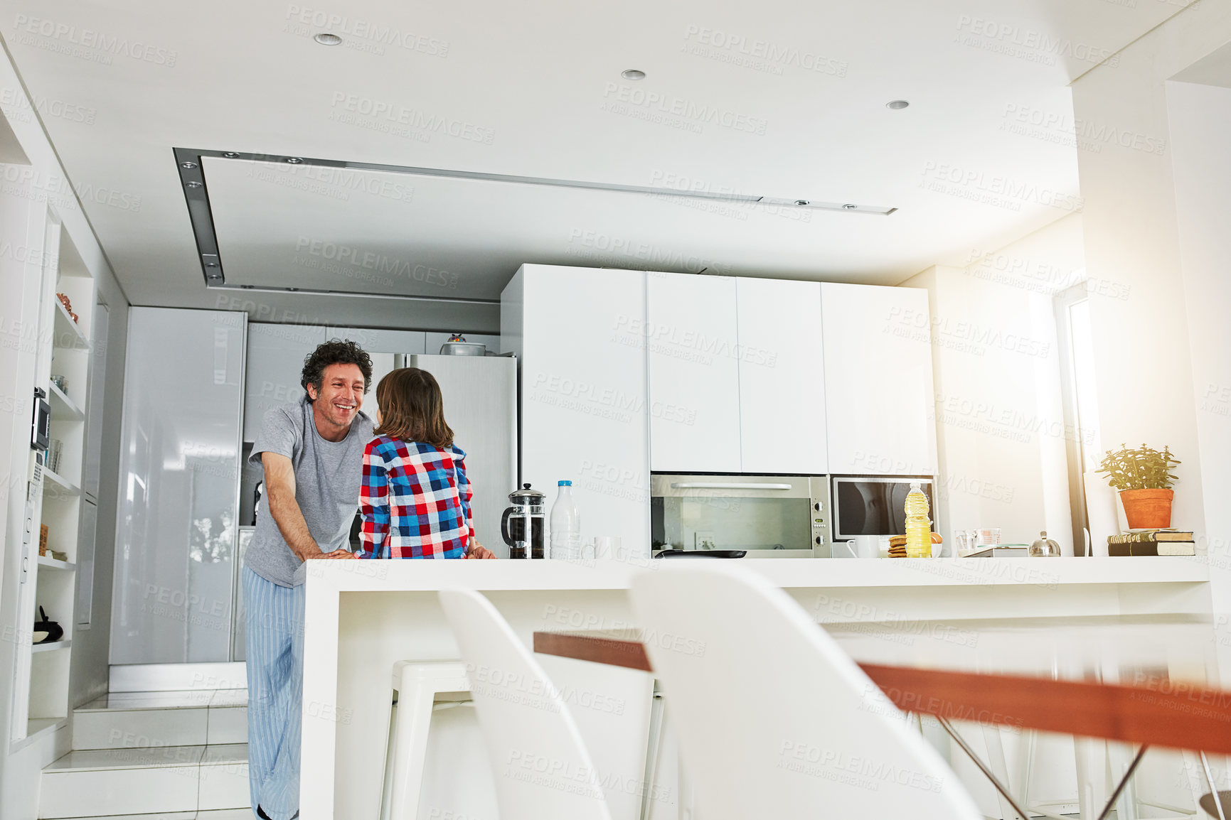 Buy stock photo Shot of a mature father and his young son in the kitchen at home