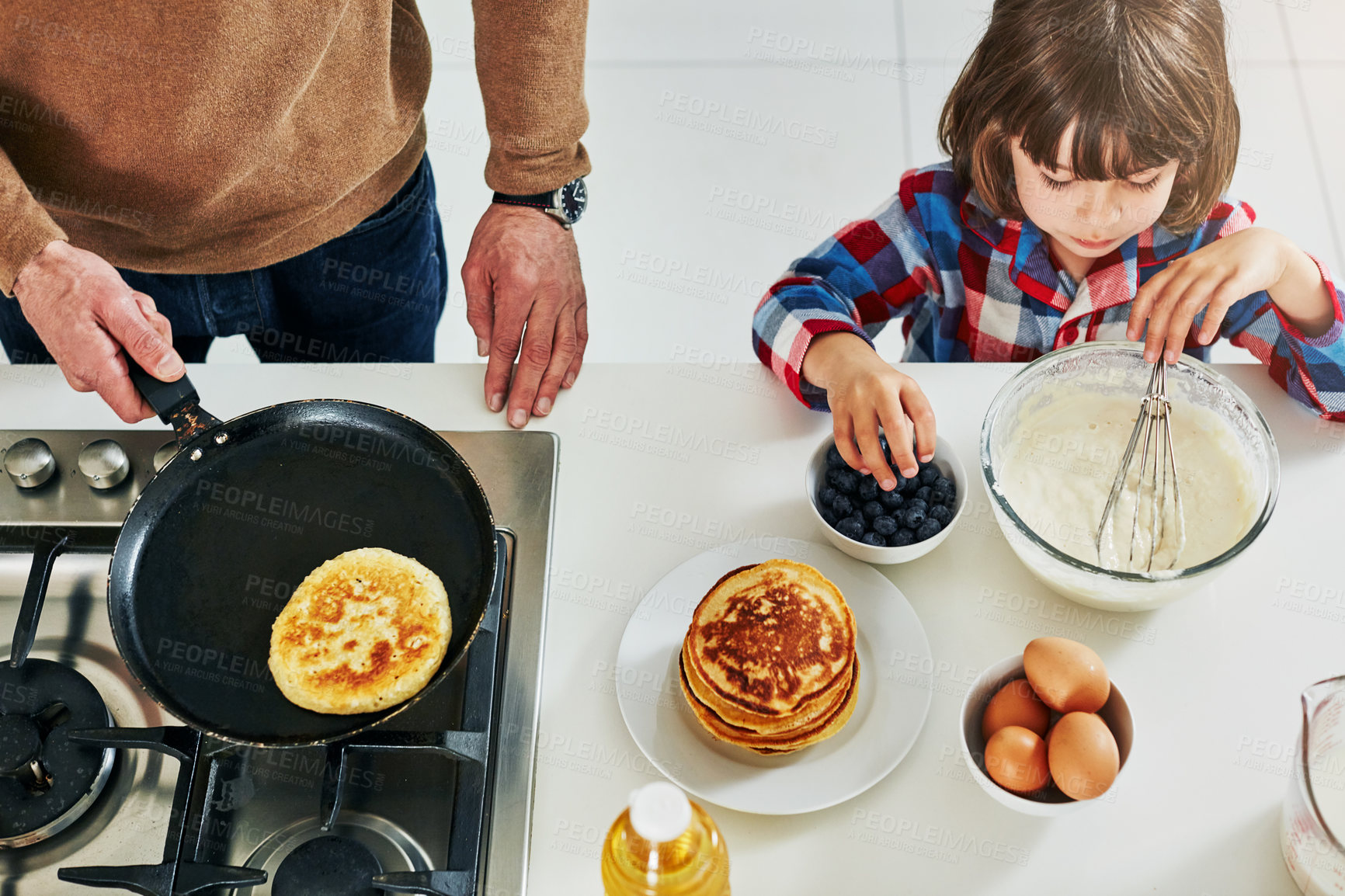 Buy stock photo Hands, father and boy with pancakes, breakfast and bonding together with hobby, ingredients and help. Closeup, single parent and kid with dad, healthy food and breakfast with break, home and learning