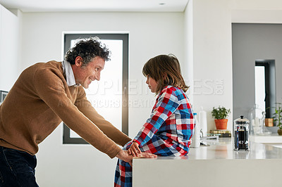 Buy stock photo Dad, boy and kitchen for conversation in home, smile and love for discussion with child. Coffee, morning and pajamas for breakfast and talking with father person, cooking or bonding for nutrition