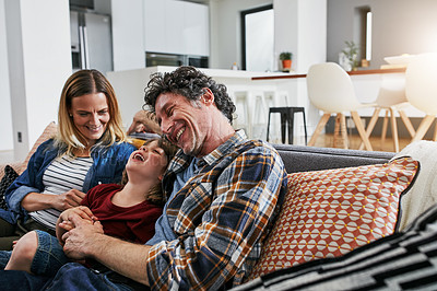 Buy stock photo Mother, father and kid laughing on sofa in living room for love, care and fun bonding together in family home. Happy young boy, cute child and relax with parents in lounge, happiness and smile 