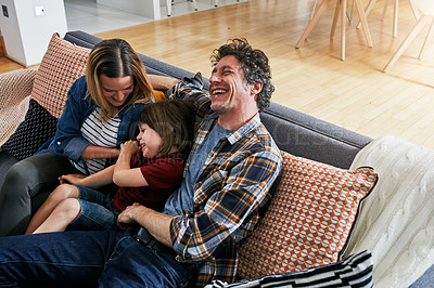 Buy stock photo Parents, family and child laughing for tickles on sofa in lounge with love, care and quality time to relax together. Happy boy playing funny game with mother, father and comedy in living room at home