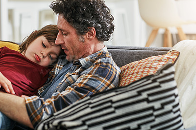 Buy stock photo Cropped shot of an adorable little boy sleeping on his mature father's chest on the sofa at home