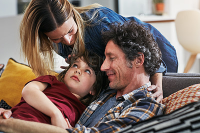 Buy stock photo Cropped shot of an adorable little boy resting on his mature father's chest on the sofa at home