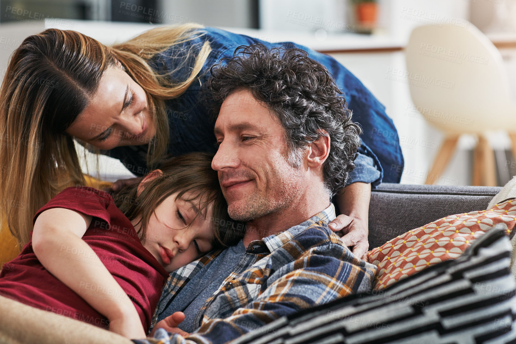 Buy stock photo Cropped shot of an adorable little boy sleeping on his mature father's chest on the sofa at home