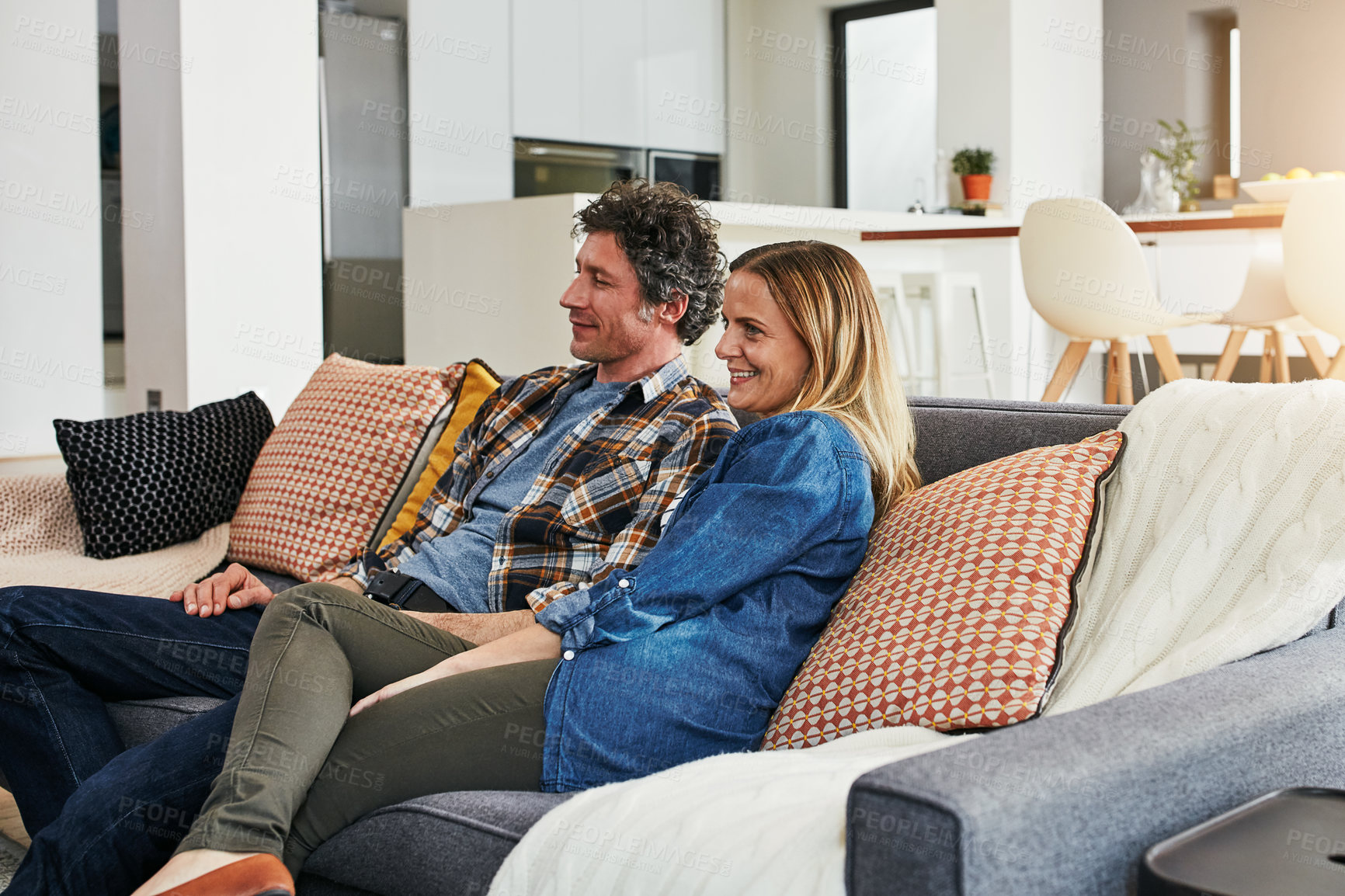 Buy stock photo Happy couple, relax and watching tv in home for movie, film show and news broadcast in living room. Mature man, woman and smile on sofa for television series, video subscription or streaming platform