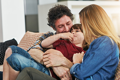 Buy stock photo Cropped shot of an affectionate family of three relaxing on the sofa at home