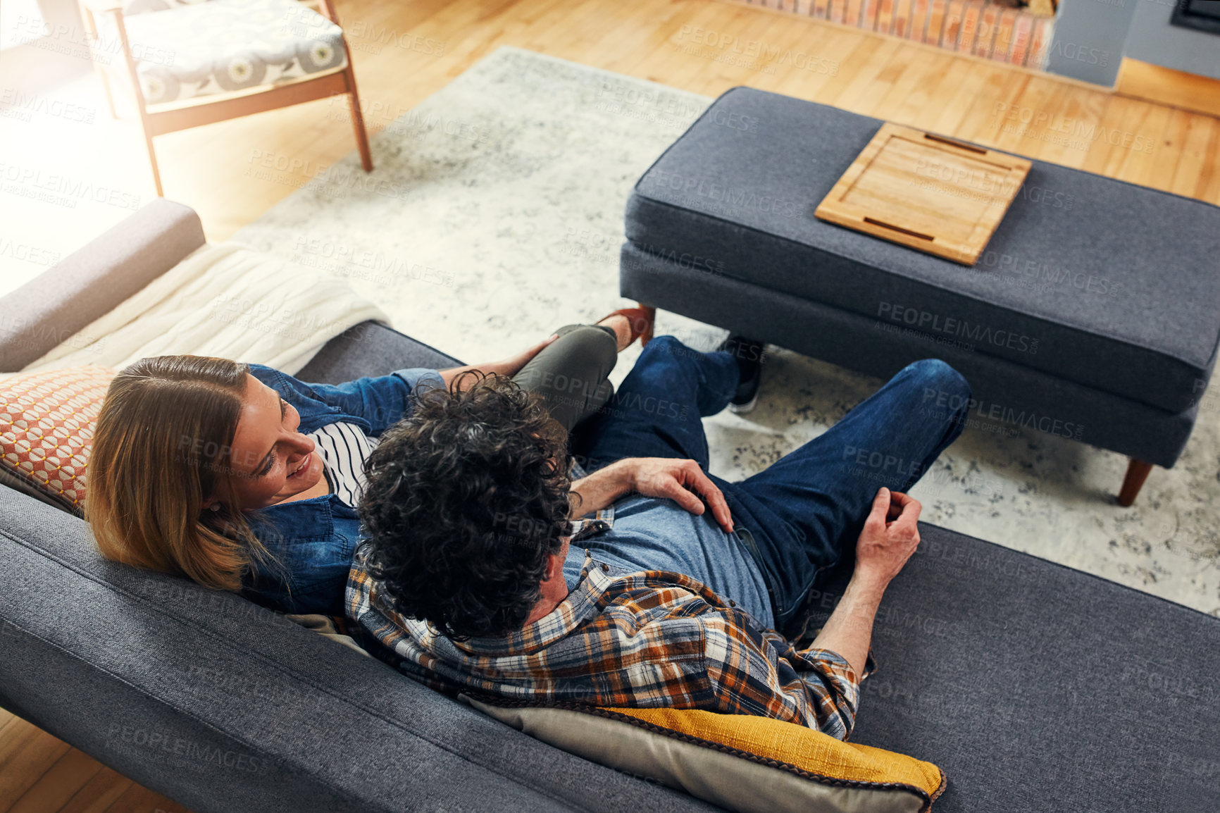 Buy stock photo Top view, happy couple and relax on couch in home for quality time, love and care of conversation, discussion and support. Man, woman and talking on sofa for break, bonding and happiness together 