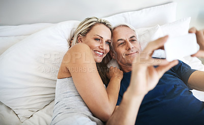 Buy stock photo Love, relax and selfie with mature couple in bedroom for social media, valentines day and streaming. Picture, memory and happiness with man and woman at home for marriage, photography and post