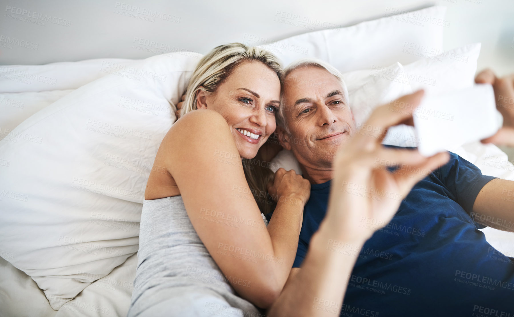 Buy stock photo Love, relax and selfie with mature couple in bedroom for social media, valentines day and streaming. Picture, memory and happiness with man and woman at home for marriage, photography and post