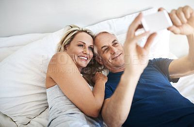 Buy stock photo Love, smile and selfie with mature couple in bedroom for social media, valentines day and booking review. Picture, memory and happiness with man and woman at home for marriage, photography and post