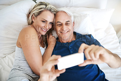 Buy stock photo Love, morning and selfie with mature couple in bedroom for social media, valentines day and booking review. Picture, memory and happiness with man and woman at home for marriage, photography and post