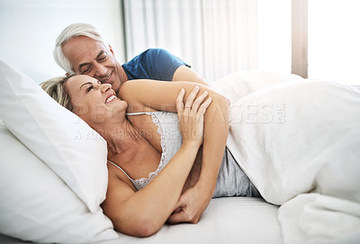 Buy stock photo Cuddle, mature or happy couple resting in bed in home for marriage, commitment or loyalty to partner. Morning, love or senior people lying for support with romance, care or trust for bonding together