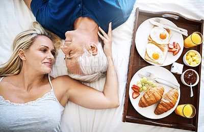 Buy stock photo Resting, above or couple with breakfast in bed for wellness, brunch or food together to relax in home. Mature, wake up or people eating for healthy diet, nutrition or eggs on Valentines day for love