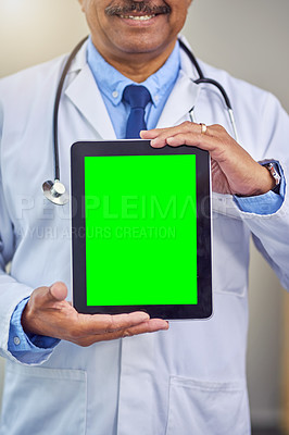 Buy stock photo Shot of an unrecognizable male doctor holding up a digital tablet in front of him while standing inside of a hospital during the day