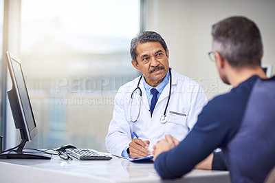 Buy stock photo Medical, discussion and doctor in a consultation with a patient analyzing diagnosis in the clinic. Professional, conversation and mature male healthcare worker talking to man in the medicare hospital