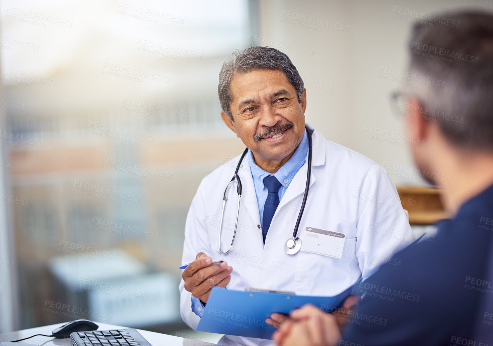 Buy stock photo Healthcare, discussion and doctor with a patient for a consultation in the office in clinic. Professional, conversation and mature male medical worker talking to man on diagnosis in medicare hospital