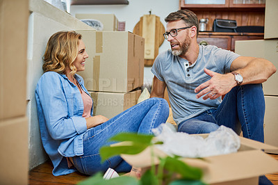 Buy stock photo Happy couple, relax and moving in with box for new home, real estate or renovation together. Man, woman or owners with smile or discussion for house makeover, property or start with boxes or packages