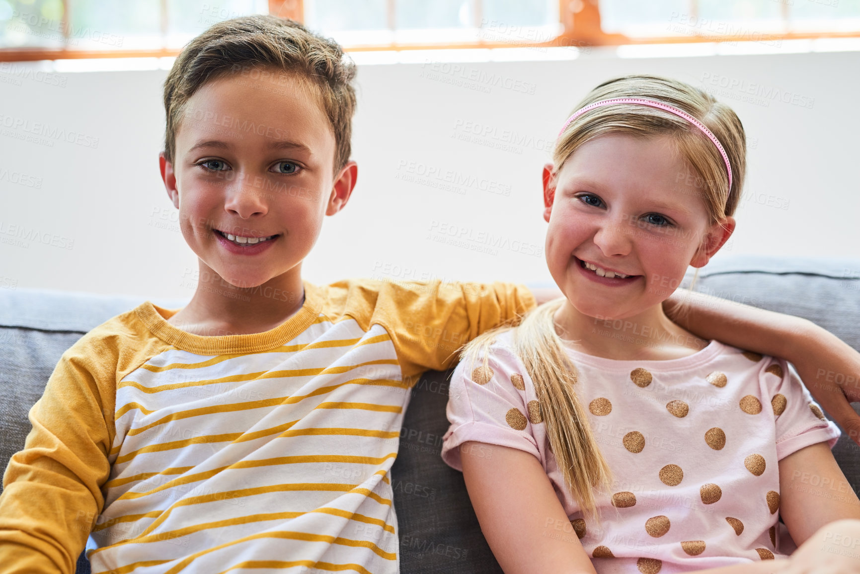 Buy stock photo Portrait of an adorable brother and sister chilling on the sofa in the living room at home