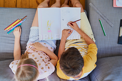 Buy stock photo Children, siblings and drawing with book above on sofa for learning, coloring or sketching at home. Top view, kids or brother and sister scribling, writing or skills for sketchbook activity at house