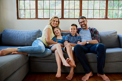 Buy stock photo Shot of an affectionate family on the sofa in the living room at home