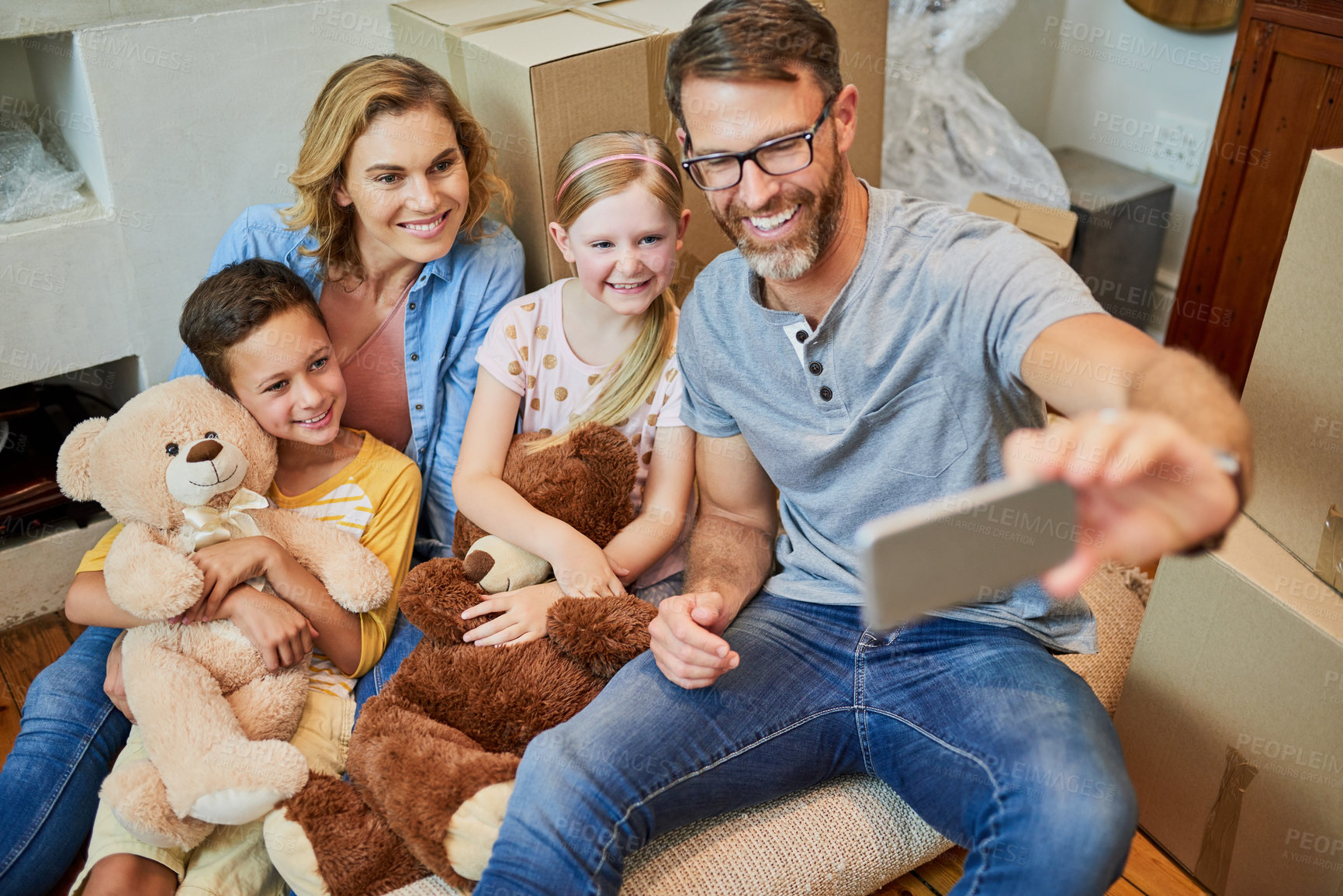 Buy stock photo Cropped shot of an affectionate family taking a selfie together at home