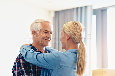 Buy stock photo Shot of an affectionate mature couple embracing at home