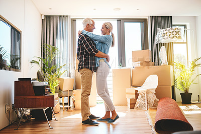 Buy stock photo Shot of a happy mature couple embracing on moving day