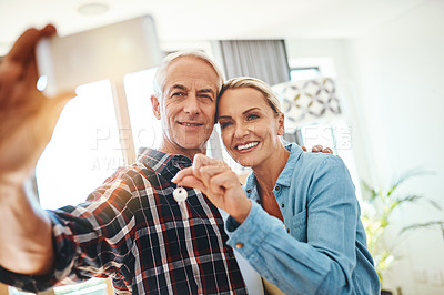 Buy stock photo Shot of a happy mature couple taking a selfie on moving day