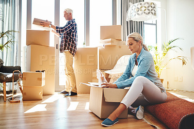 Buy stock photo Shot of a mature couple packing boxes on moving day