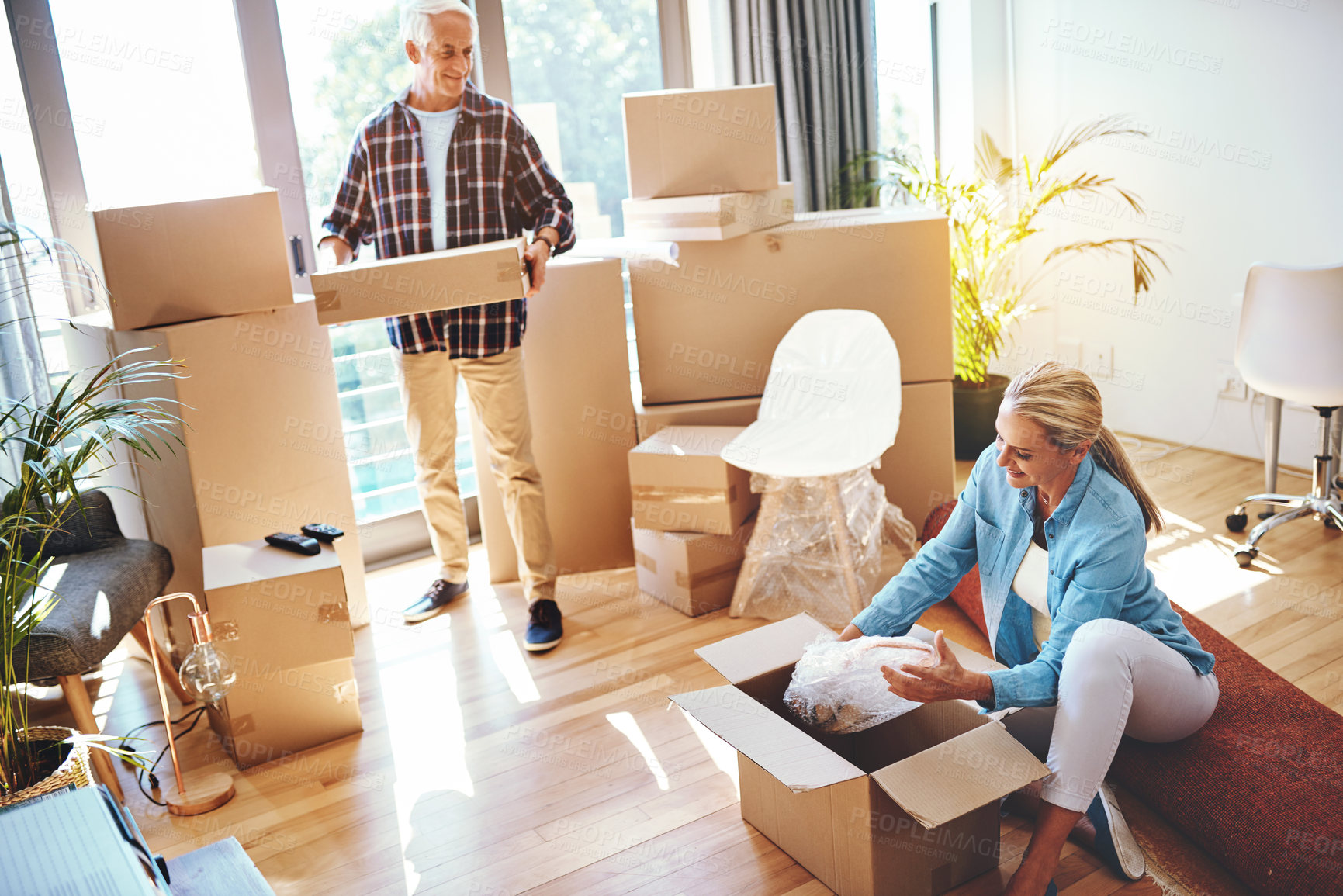 Buy stock photo Shot of a mature couple packing boxes on moving day