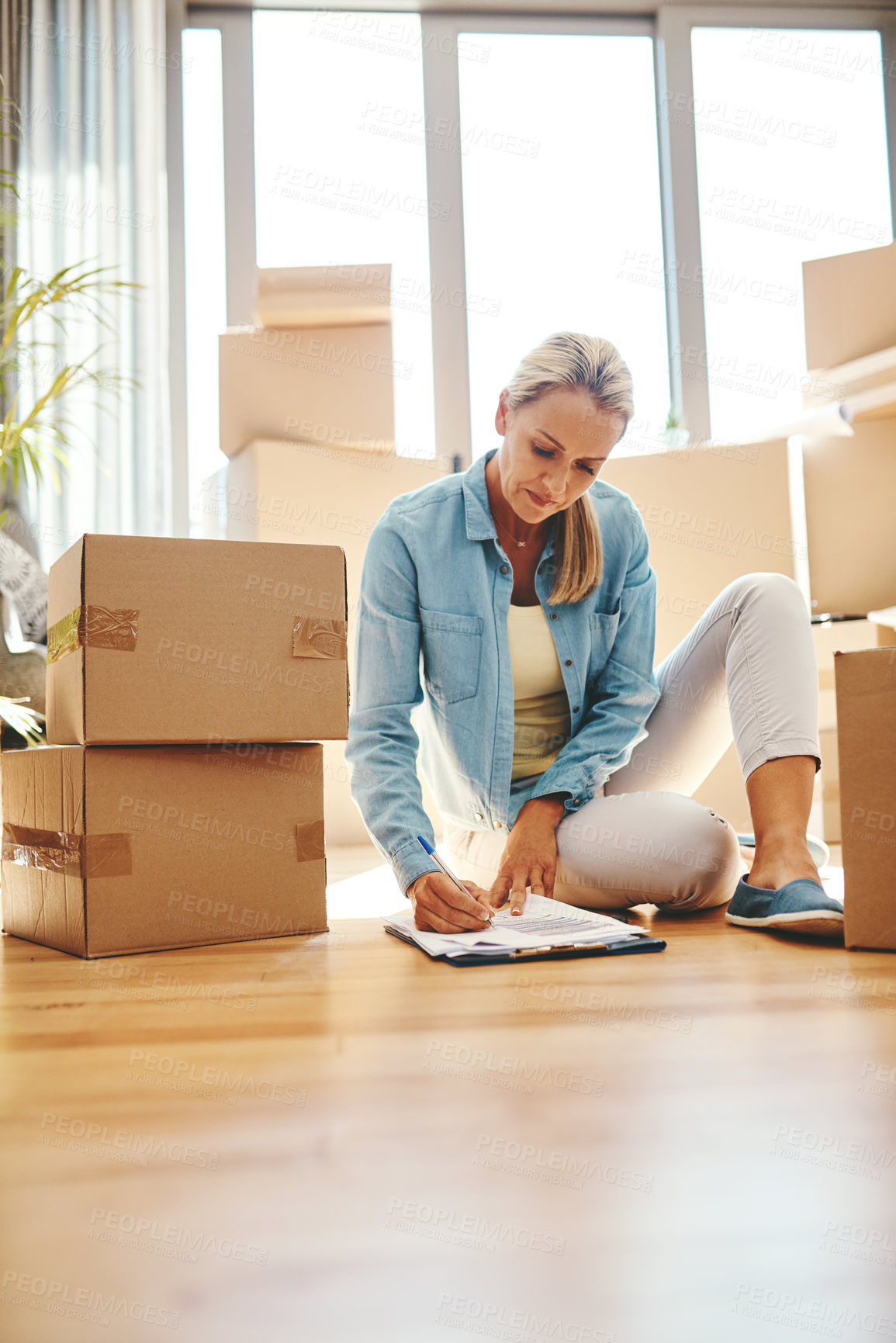 Buy stock photo Woman, boxes and sign paperwork in the living room for investment with a contract. Investing, document and writing on the floor with a lease at a new home for retirement and finance for savings.