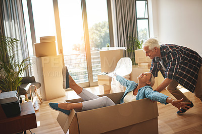 Buy stock photo Shot of a happy mature couple having fun on moving day