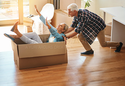 Buy stock photo Shot of a happy mature couple having fun on moving day