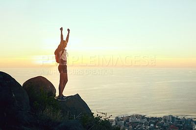 Buy stock photo Shot of a young woman celebrating while out on a hike through the mountains