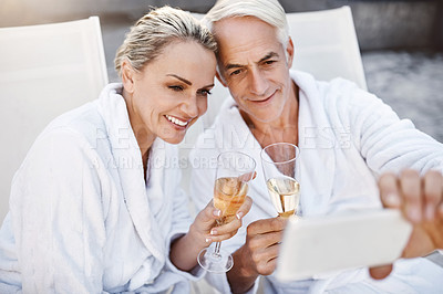 Buy stock photo Senior couple, selfie and champagne by swimming pool, toast and love at luxury resort on vacation. Mature man, woman and memory by water for celebration, drinks and cheers with wine glass in Greece