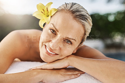 Buy stock photo Happy woman, portrait and relax with flower at beauty salon for massage, facial or treatment at outdoor resort. Female person with smile lying for stress relief, zen or physical therapy at luxury spa